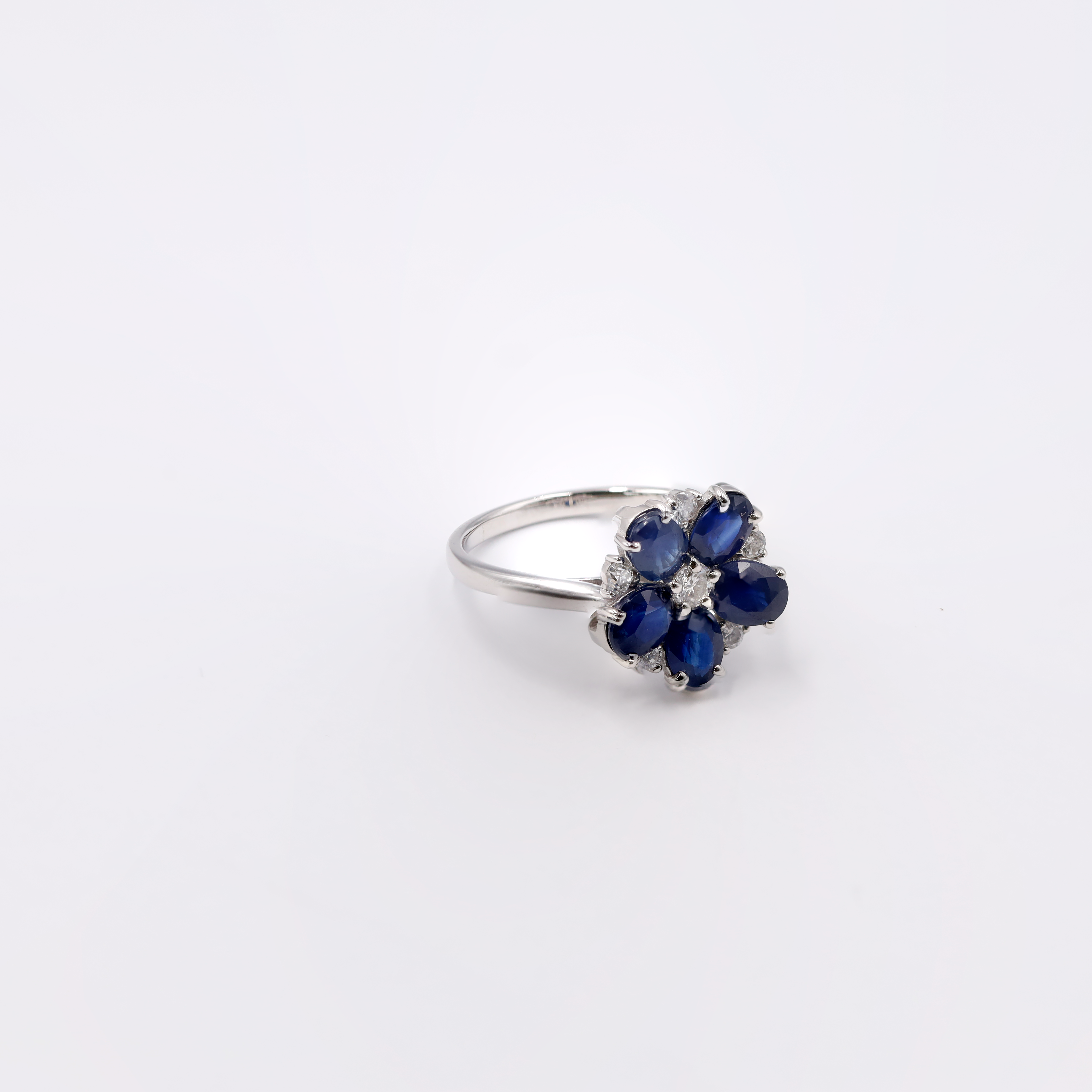 Platinum ring showcasing a substantial 2.27 carat blue Sapphire center stone flanked by sparkling accent diamonds (totaling 0.49 ct), all weighing a total of 4.00 grams