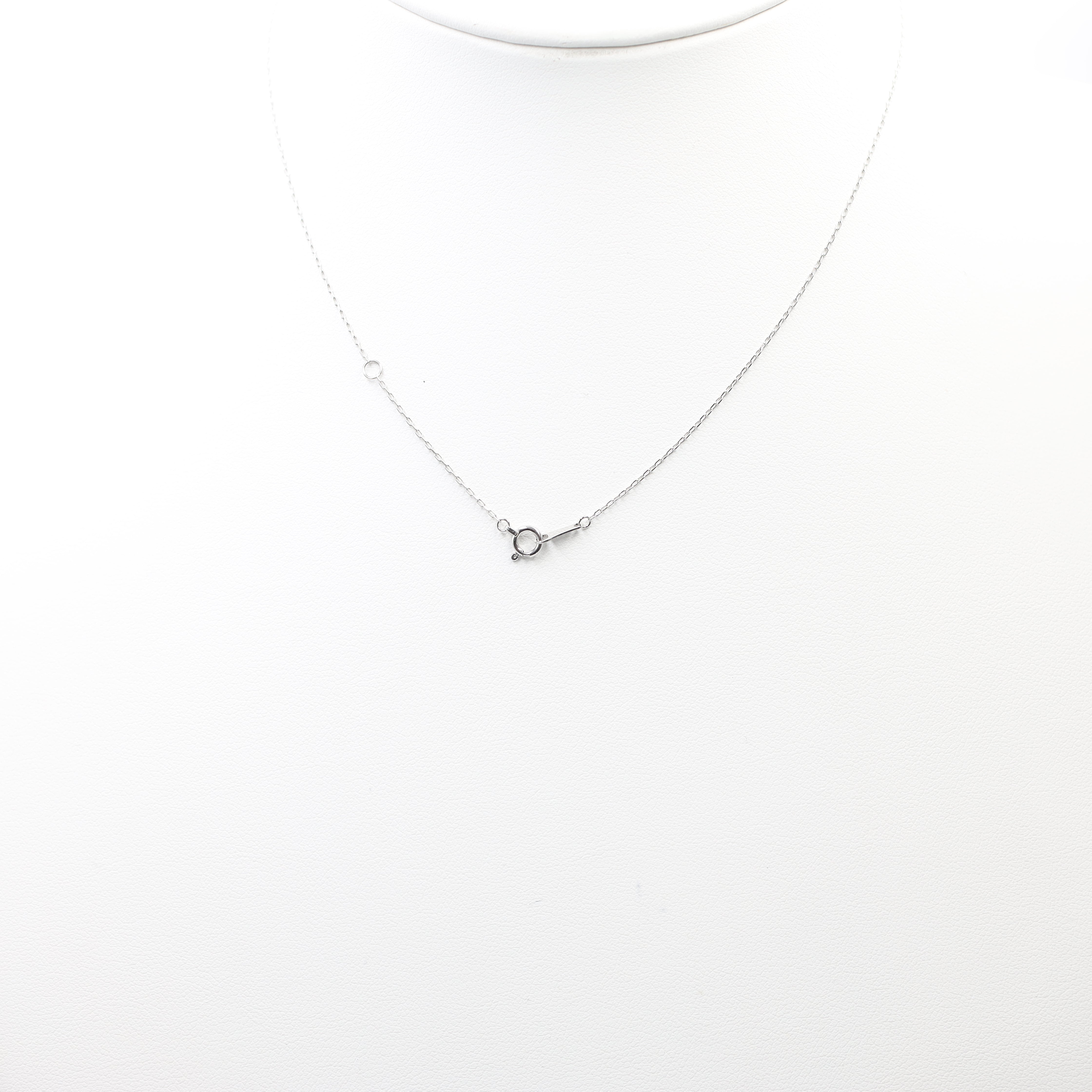 A dazzling heart-shaped diamond pendant necklace, set on a delicate white metal chain. The heart is formed by a cluster of sparkling diamonds, creating a romantic and brilliant look.